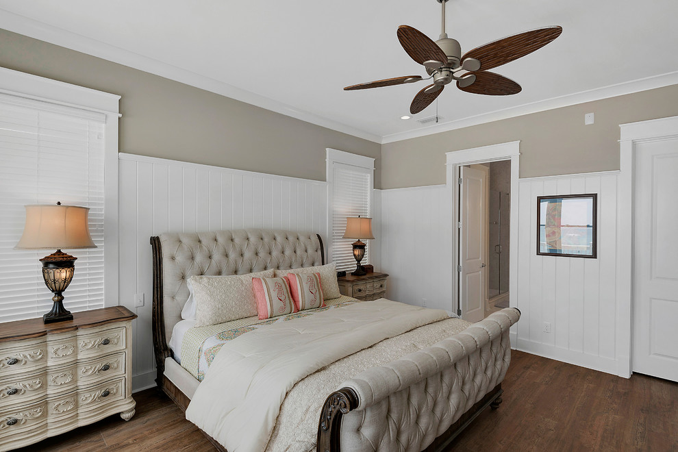 Photo of a mid-sized beach style master bedroom in Miami with beige walls, medium hardwood floors, no fireplace and brown floor.