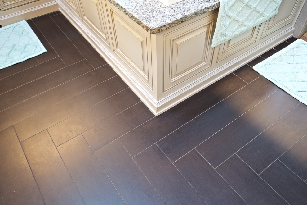 Tub/shower combo - huge transitional master black tile and ceramic tile dark wood floor tub/shower combo idea with a vessel sink, distressed cabinets, wood countertops and beige walls