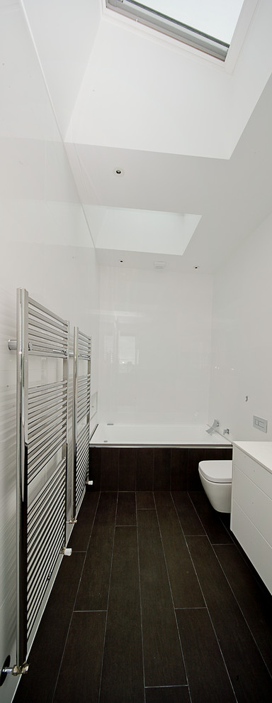 Large modern bathroom in Melbourne with an undermount sink, flat-panel cabinets, white cabinets, engineered quartz benchtops, a drop-in tub, a corner shower, porcelain tile, white walls, porcelain floors, a one-piece toilet and brown tile.