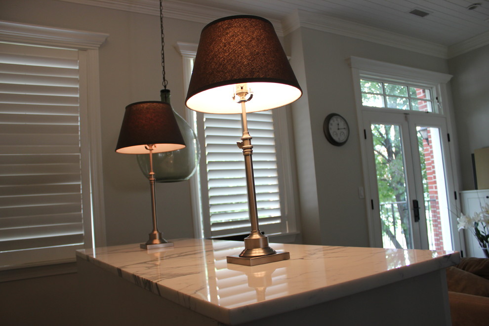 Example of a large transitional galley dark wood floor eat-in kitchen design in Baltimore with a farmhouse sink, shaker cabinets, white cabinets, wood countertops, white backsplash, ceramic backsplash, stainless steel appliances and an island