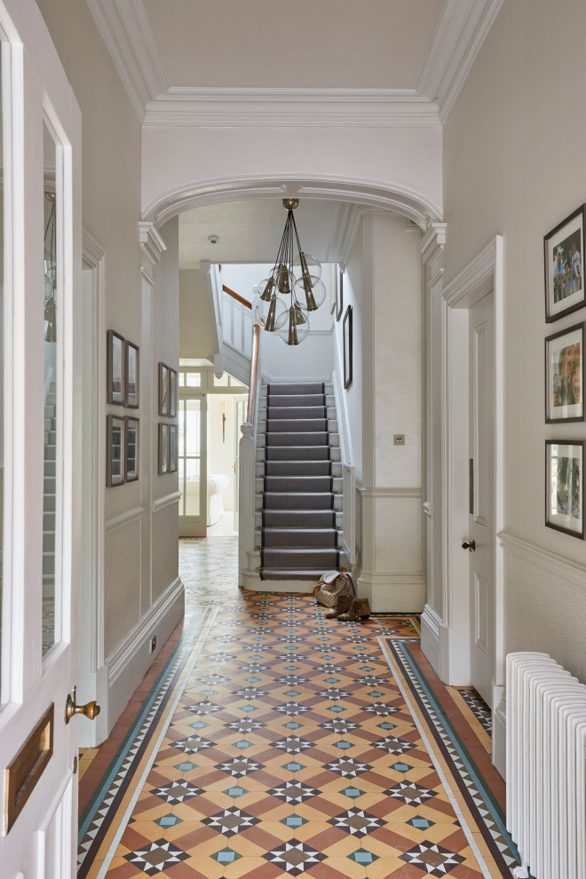 Design ideas for a large hallway in Other with beige walls, terra-cotta floors, multi-coloured floor, wallpaper and wallpaper.