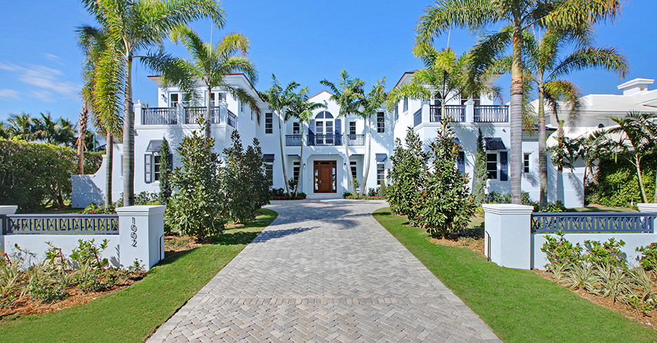 This is an example of an expansive beach style two-storey concrete blue house exterior in Miami.