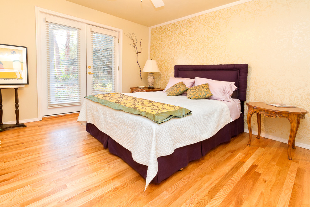 Inspiration for a large transitional guest medium tone wood floor and beige floor bedroom remodel in Boise with white walls and no fireplace