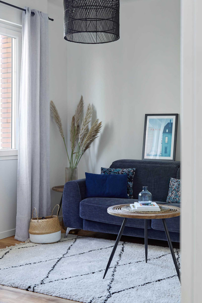 Foto di un soggiorno scandinavo di medie dimensioni con pavimento in legno massello medio, camino bifacciale e TV a parete