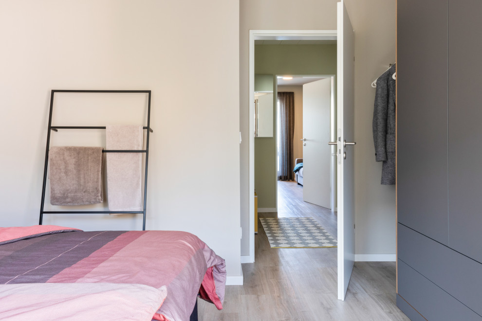 Kleines Modernes Schlafzimmer mit grauer Wandfarbe, Vinylboden, grauem Boden und Tapetenwänden in Sonstige