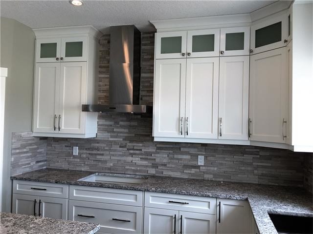 Example of a transitional kitchen design in Calgary