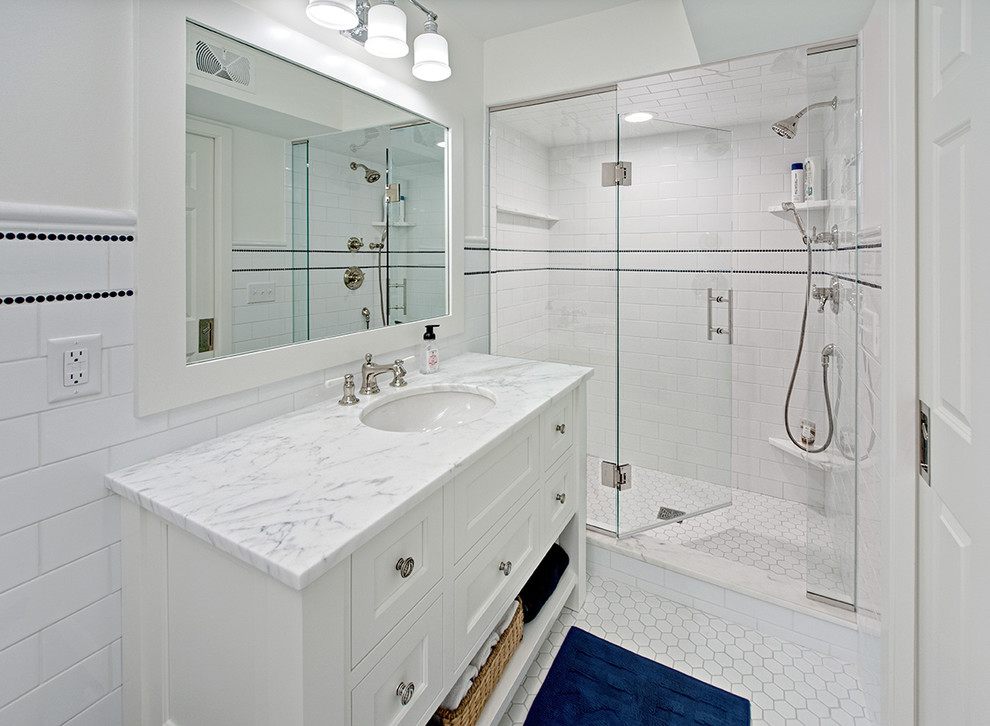 This is an example of a mid-sized transitional bathroom in Minneapolis with flat-panel cabinets, white cabinets, a double shower, white tile, white walls, porcelain floors, an undermount sink, soapstone benchtops, white floor, a hinged shower door and white benchtops.