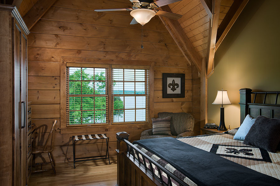 Mid-sized country master bedroom in Other with brown walls, light hardwood floors and no fireplace.