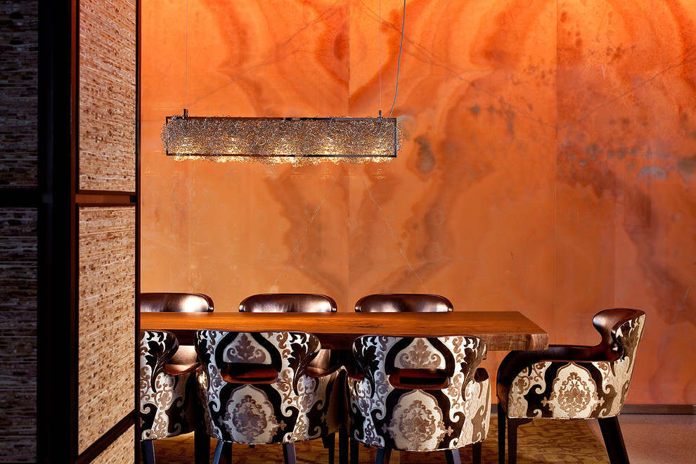 Inspiration for a contemporary dining room in Las Vegas with orange walls.
