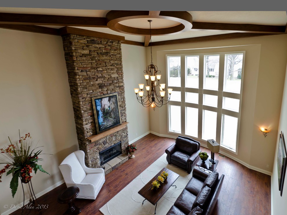 Large arts and crafts formal open concept living room in Cleveland with beige walls, medium hardwood floors, a standard fireplace, a stone fireplace surround and no tv.