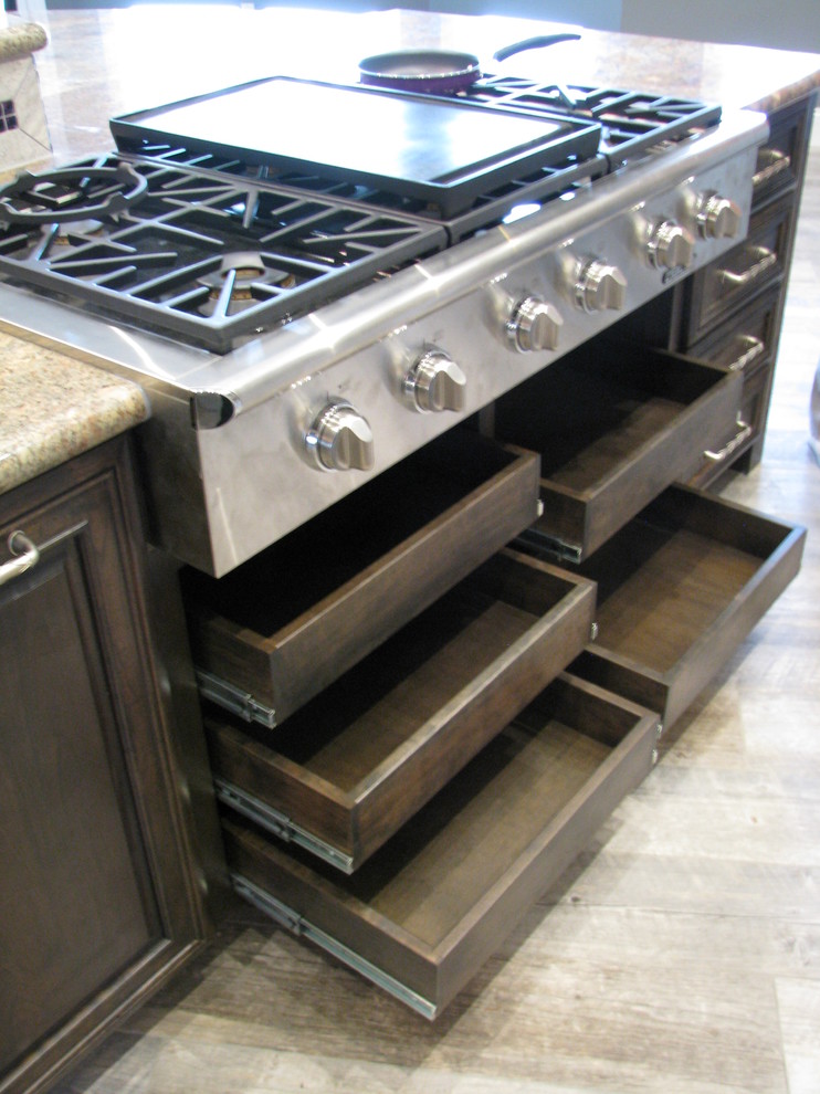 Open concept kitchen - huge transitional l-shaped porcelain tile open concept kitchen idea in Phoenix with an undermount sink, raised-panel cabinets, gray cabinets, granite countertops, gray backsplash, stone tile backsplash, stainless steel appliances and an island