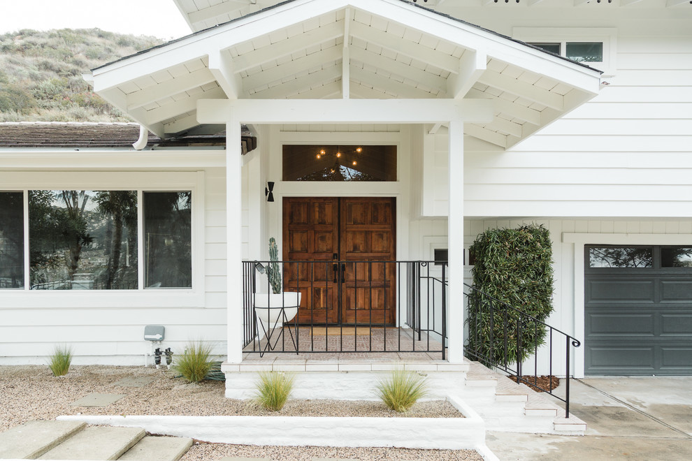 Design ideas for a country front door in San Diego with a double front door and a medium wood front door.