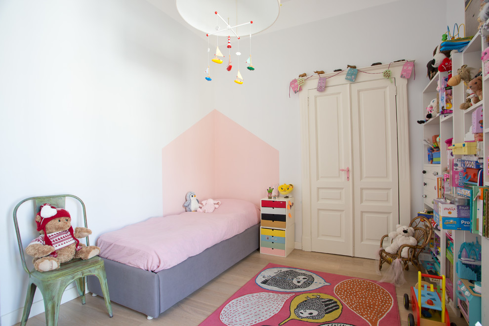 Design ideas for a large eclectic kids' bedroom for kids 4-10 years old and girls in Naples with multi-coloured walls, medium hardwood floors and beige floor.