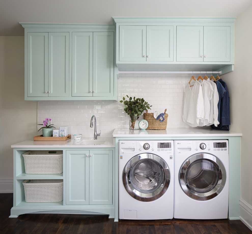 Inspiration for a mid-sized traditional single-wall dedicated laundry room in Nashville with an undermount sink, turquoise cabinets, quartz benchtops, dark hardwood floors, a side-by-side washer and dryer, brown floor, white benchtop, recessed-panel cabinets and beige walls.