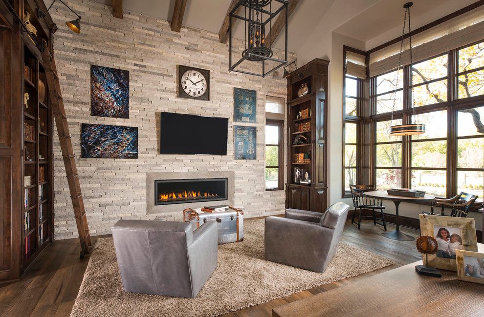 Country family room in Dallas with a library, beige walls, dark hardwood floors, a ribbon fireplace and a wall-mounted tv.