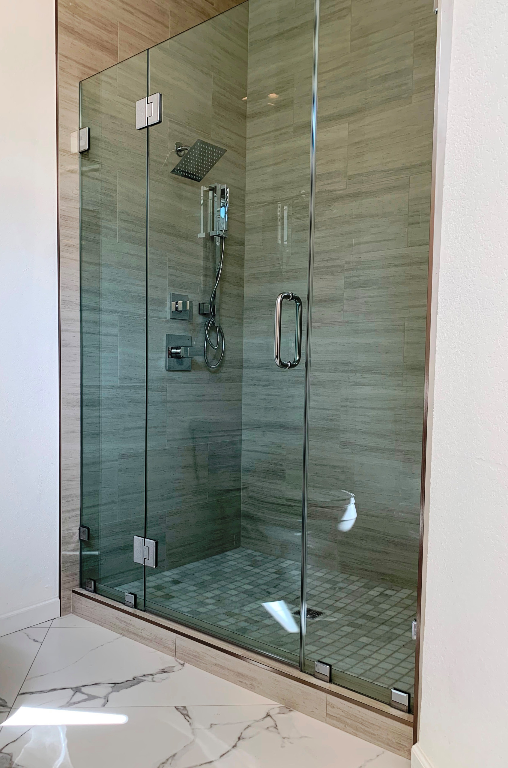 Modern shower enclosure with custom shower door.