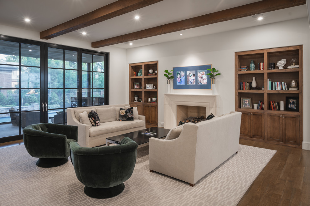 This is an example of a transitional family room in Dallas with white walls, dark hardwood floors, a standard fireplace and brown floor.