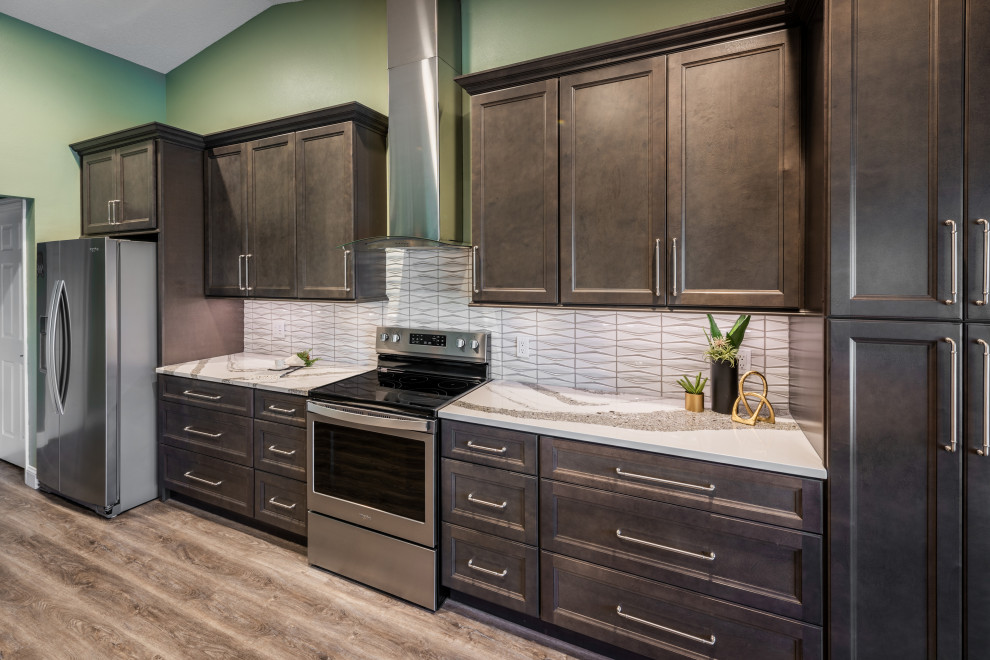 Eat-in kitchen - huge transitional single-wall vinyl floor and gray floor eat-in kitchen idea in Orlando with an undermount sink, recessed-panel cabinets, gray cabinets, quartz countertops, white backsplash, porcelain backsplash, stainless steel appliances, an island and white countertops