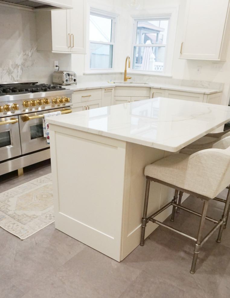 Transitional vinyl floor and gray floor kitchen photo with an undermount sink, shaker cabinets, gray cabinets, quartzite countertops, stone slab backsplash, stainless steel appliances and an island