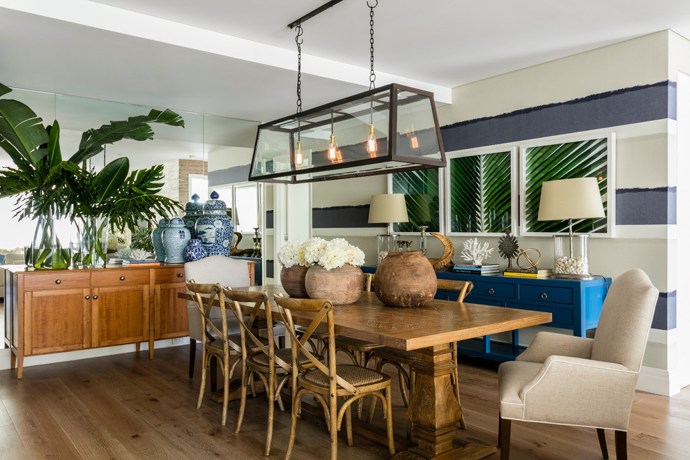 Mid-sized beach style open plan dining in Sydney with white walls, medium hardwood floors and no fireplace.