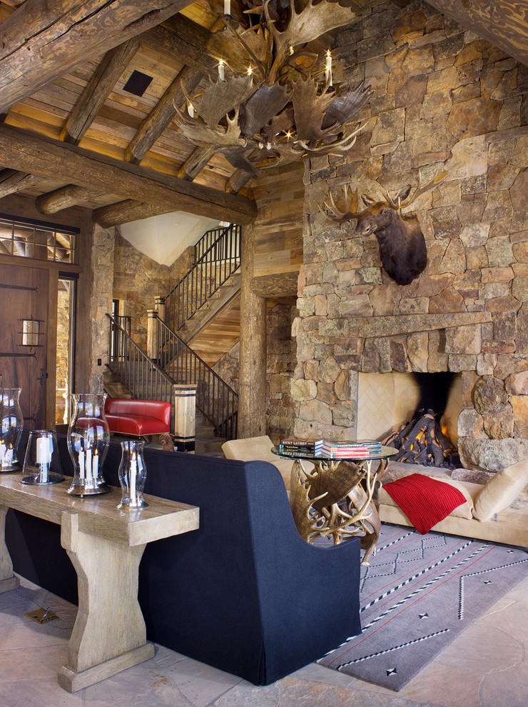 Example of a mountain style formal and open concept gray floor home design design in Denver with a standard fireplace, a stone fireplace, brown walls and a wall-mounted tv