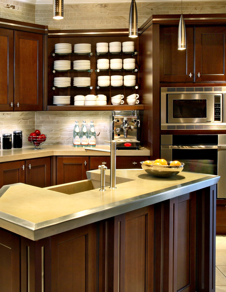 Example of a small l-shaped ceramic tile eat-in kitchen design in Phoenix with a farmhouse sink, recessed-panel cabinets, medium tone wood cabinets, concrete countertops, beige backsplash, stone tile backsplash, stainless steel appliances and an island