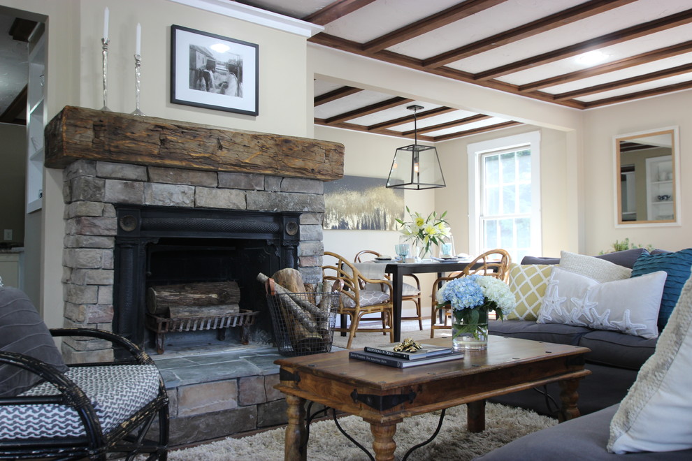 Inspiration for a mid-sized country open concept living room in Portland Maine with beige walls, medium hardwood floors, a standard fireplace and a stone fireplace surround.