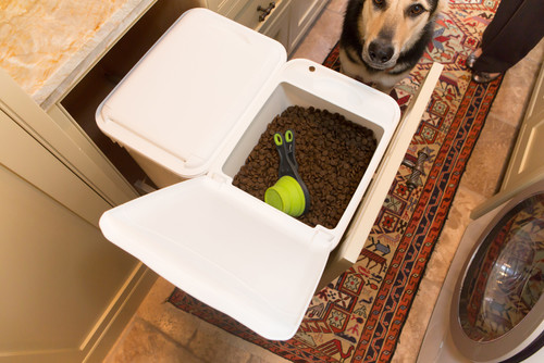 When planning a dog-friendly renovation, don’t overlook storage for pet essentials. Here, a pull-out drawer keeps dog food neatly tucked away and fresh.