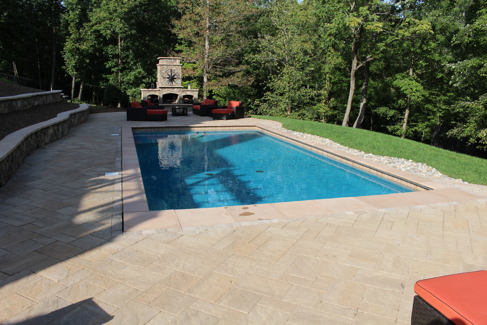 Example of a mid-sized mountain style backyard concrete paver and rectangular natural pool design in DC Metro