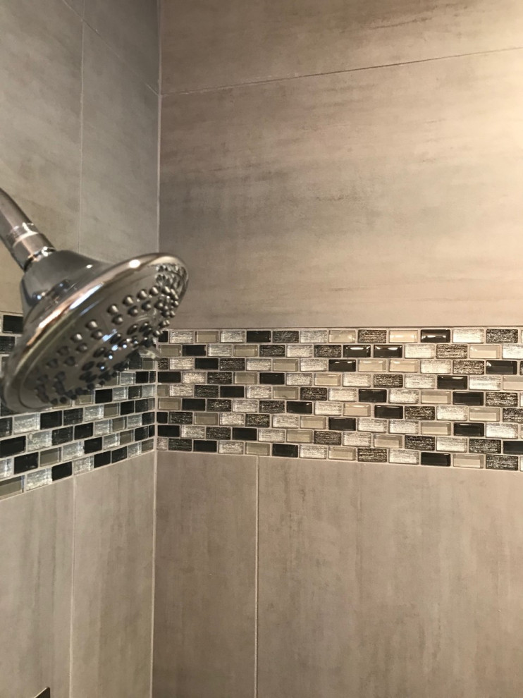 This is an example of a mid-sized transitional kids bathroom in Other with an alcove tub, gray tile, porcelain tile, porcelain floors, grey floor, a sliding shower screen, a niche, a single vanity and a built-in vanity.