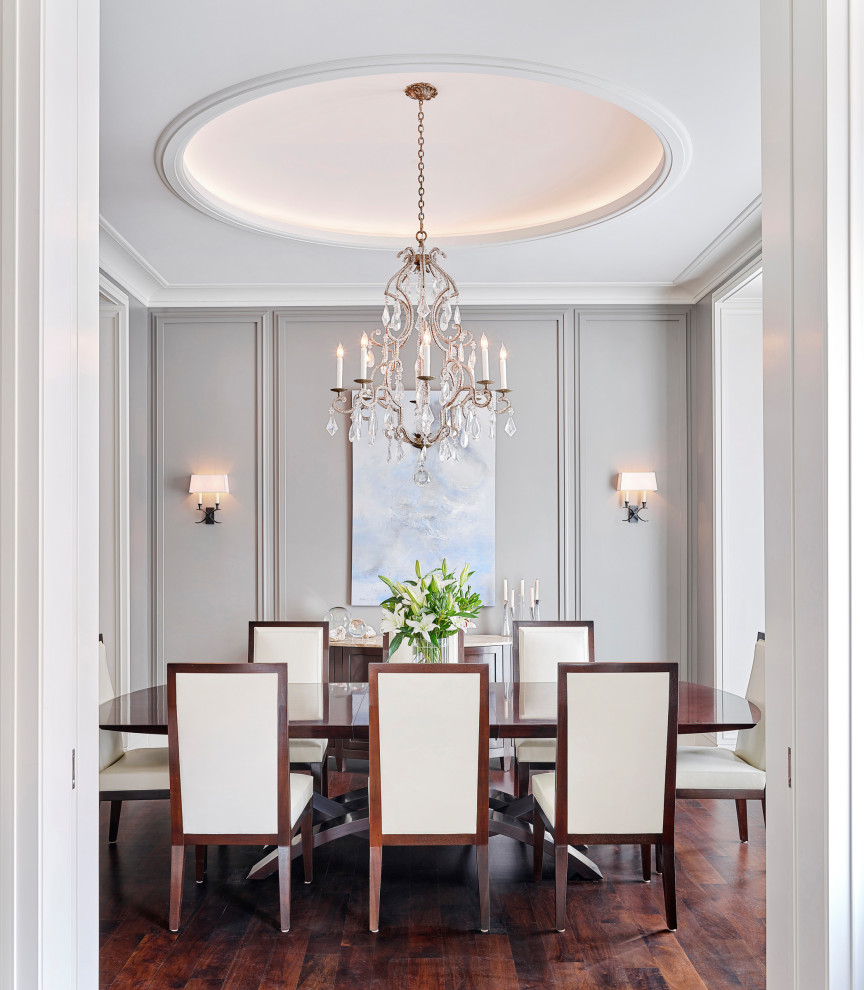 Transitional dining room in Chicago with grey walls, dark hardwood floors and brown floor.