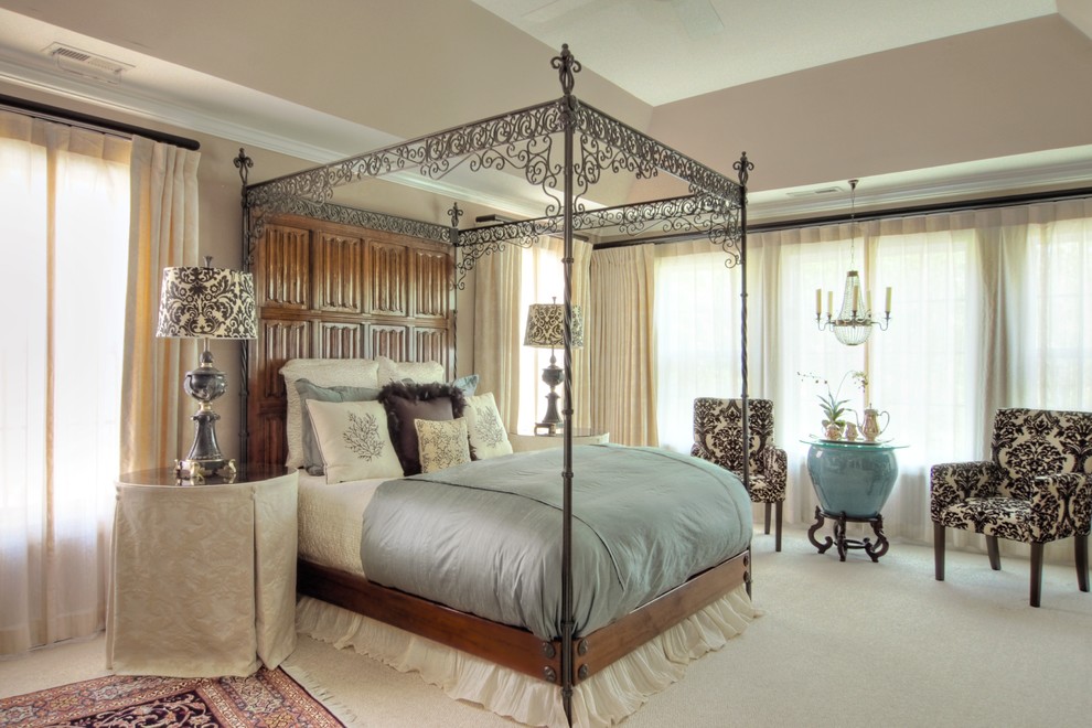 Mid-sized traditional master bedroom in Raleigh with carpet, a standard fireplace, a wood fireplace surround, beige floor, beige walls and recessed.