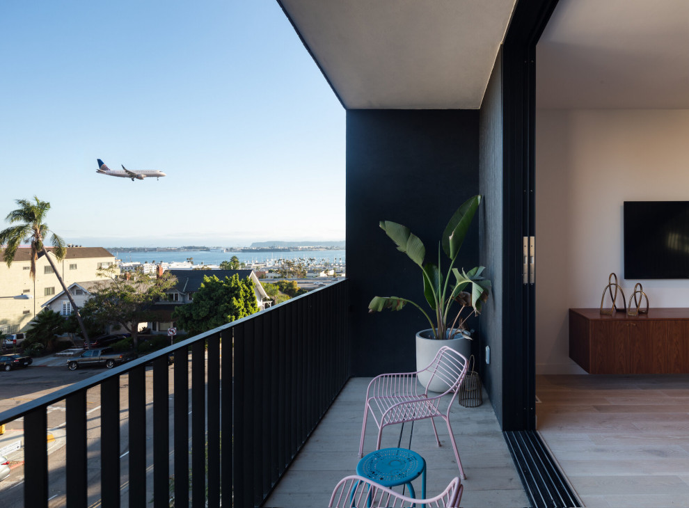 Inspiration for a small midcentury balcony in San Diego with with privacy feature, a roof extension and metal railing.