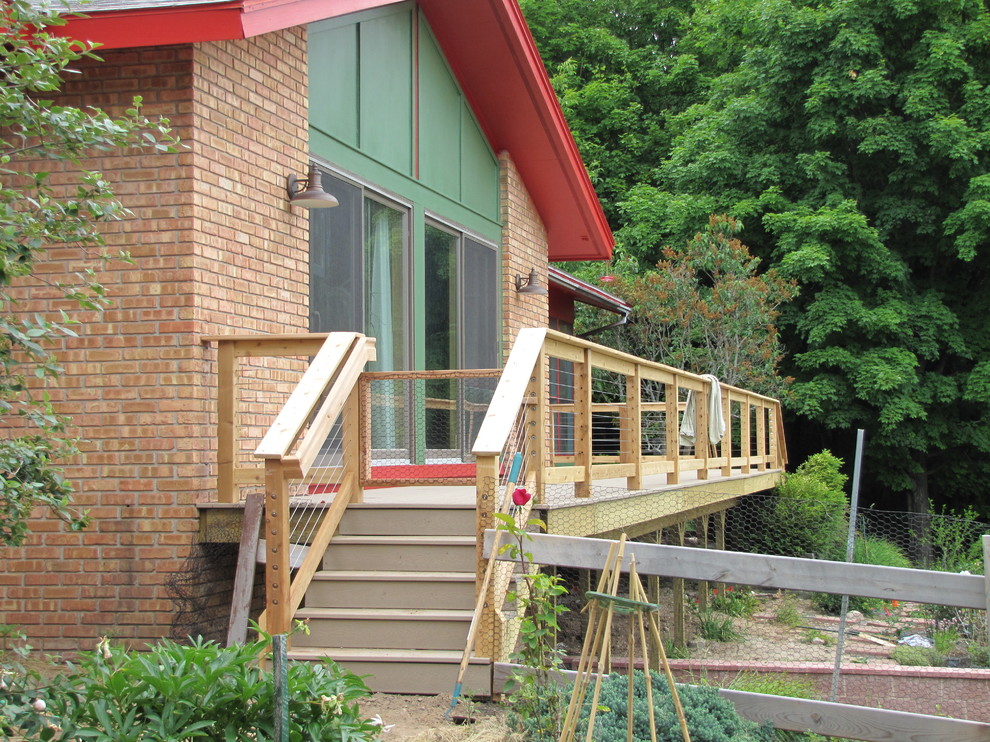 Large mountain style backyard deck photo with no cover