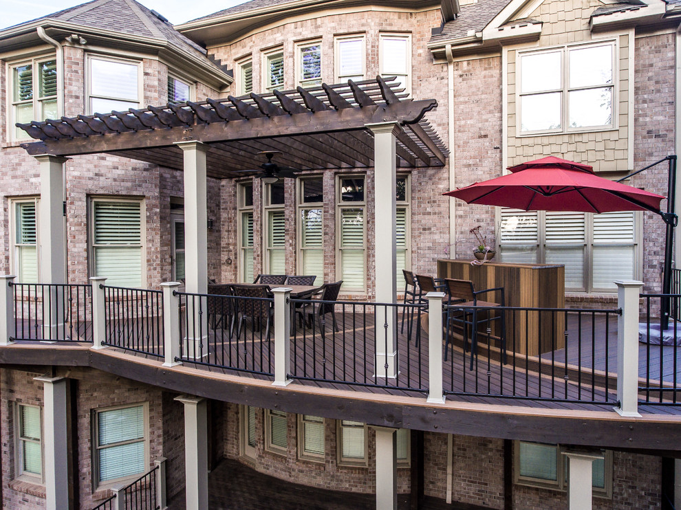 Photo of a large arts and crafts backyard deck in Atlanta with an outdoor kitchen and a pergola.