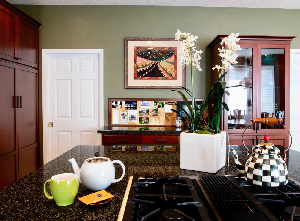 Inspiration for a large eclectic u-shaped ceramic tile eat-in kitchen remodel with a double-bowl sink, recessed-panel cabinets, dark wood cabinets, granite countertops, black backsplash, stone slab backsplash, stainless steel appliances and an island