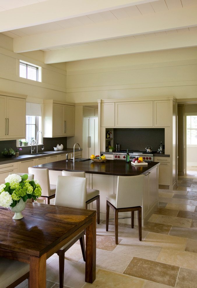 Example of a transitional u-shaped beige floor open concept kitchen design in Boston with shaker cabinets, beige cabinets, black backsplash and stainless steel appliances
