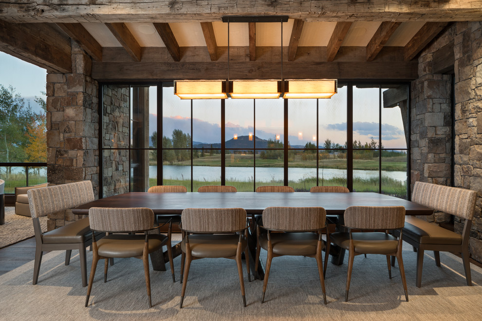 Example of a mountain style dark wood floor dining room design in Jackson with no fireplace
