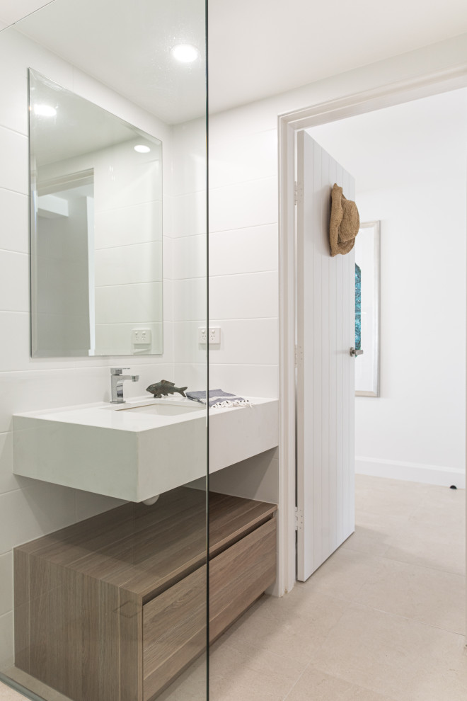 Small beach style 3/4 bathroom in Sunshine Coast with white walls, porcelain floors, beige floor, a single vanity and a built-in vanity.