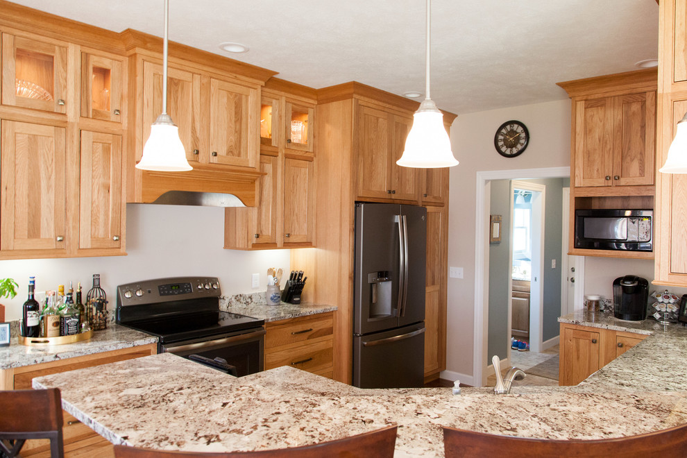 Inspiration for a mid-sized rustic u-shaped medium tone wood floor eat-in kitchen remodel with an undermount sink, shaker cabinets, light wood cabinets, granite countertops, stainless steel appliances and a peninsula