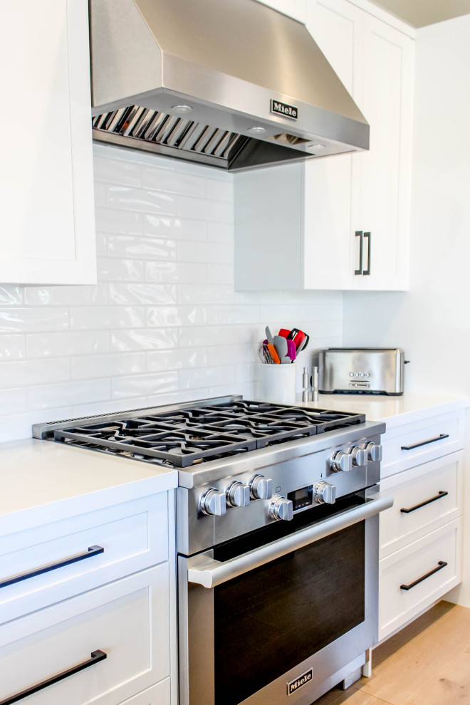 Inspiration for a transitional beige floor kitchen remodel with white backsplash, subway tile backsplash and white countertops