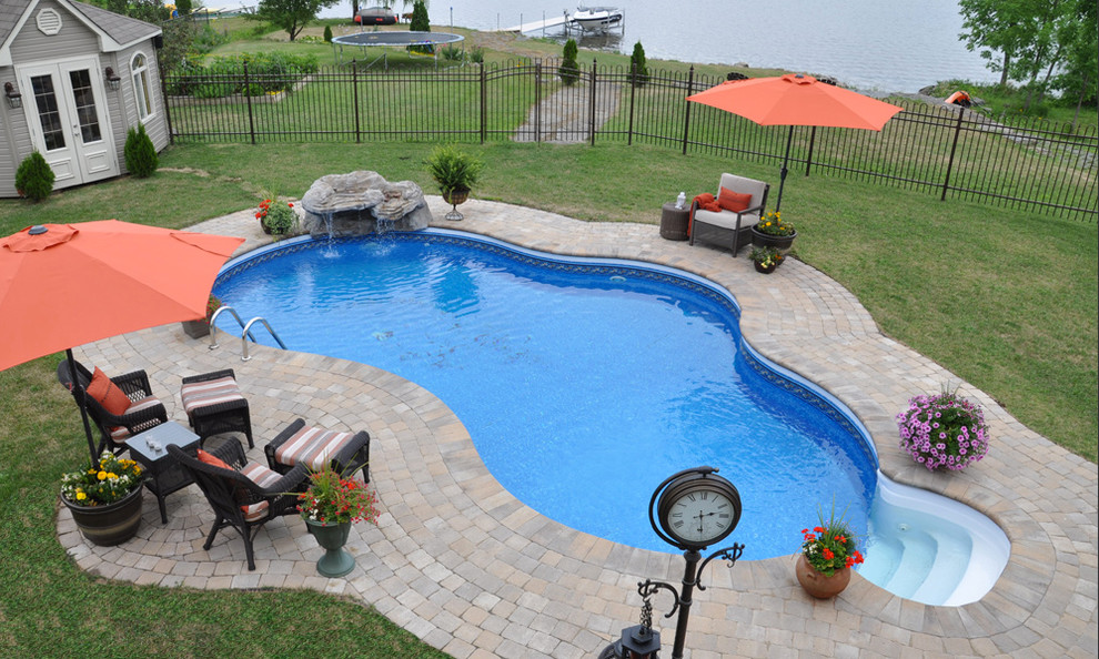 Pool - mid-sized transitional backyard brick and kidney-shaped pool idea