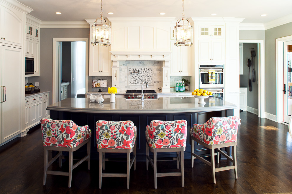 Kitchen - large traditional l-shaped dark wood floor kitchen idea in Minneapolis with an island, recessed-panel cabinets, white cabinets, quartzite countertops, white backsplash, subway tile backsplash, paneled appliances, a farmhouse sink and gray walls
