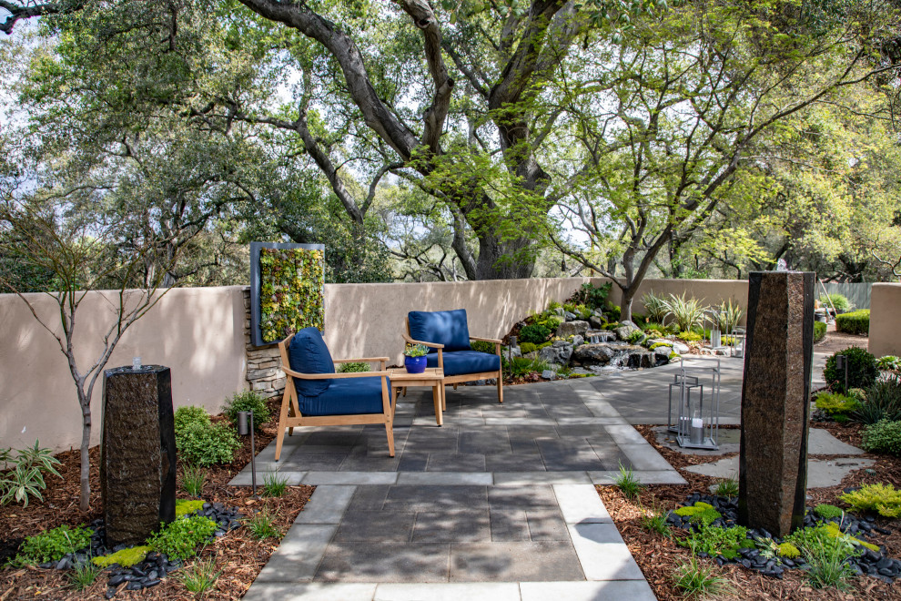 Inspiration for a small asian side yard patio in Los Angeles with a water feature, concrete pavers and no cover.