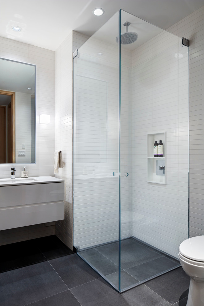 Inspiration for a small contemporary 3/4 bathroom in Vancouver with flat-panel cabinets, white cabinets, an open shower, white tile, mosaic tile, white walls, concrete floors, an undermount sink and marble benchtops.