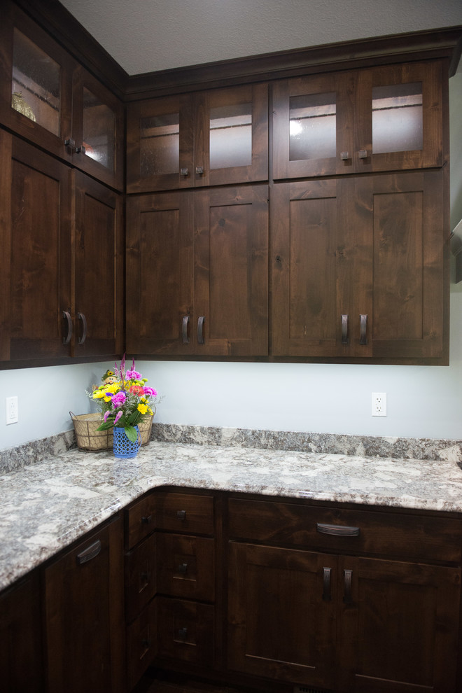 Inspiration for a transitional l-shaped open concept kitchen remodel with an undermount sink, shaker cabinets, dark wood cabinets, granite countertops, stainless steel appliances, an island and multicolored countertops