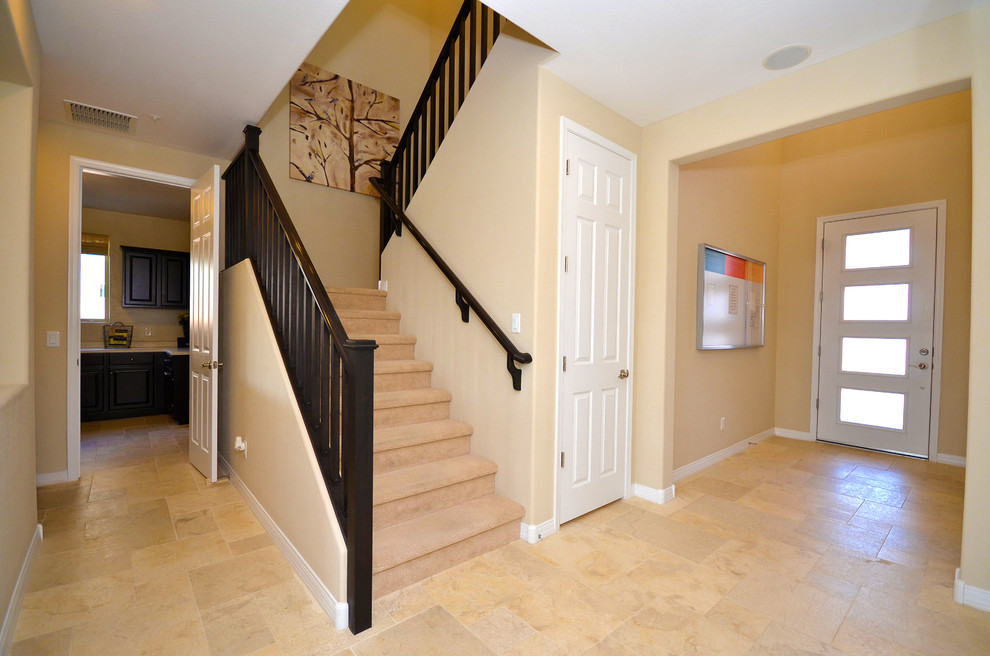 Mid-sized mediterranean carpeted l-shaped staircase in Phoenix with wood risers.