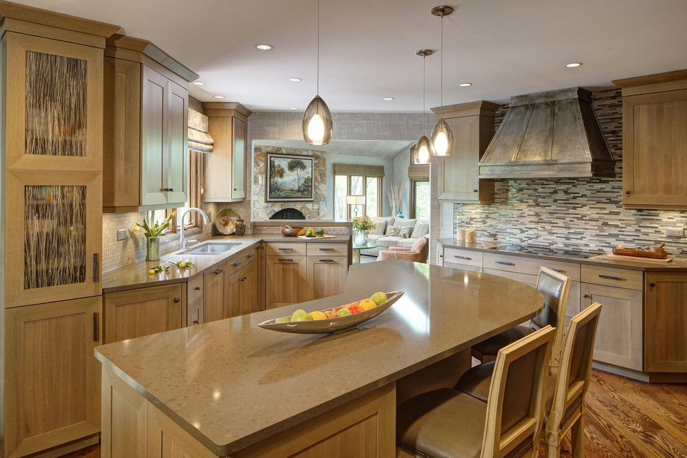 Inspiration for a transitional medium tone wood floor eat-in kitchen remodel in Chicago with a double-bowl sink, shaker cabinets, medium tone wood cabinets, quartz countertops, gray backsplash, stone tile backsplash, stainless steel appliances and an island