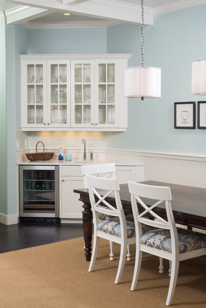 Example of a mid-sized transitional dark wood floor and brown floor kitchen/dining room combo design with blue walls and no fireplace