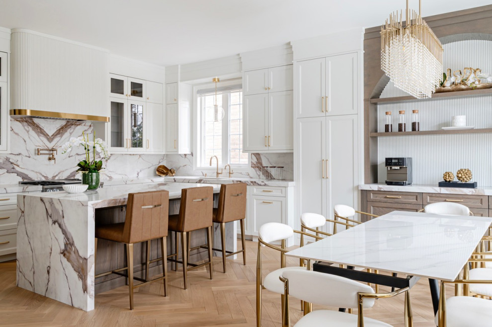 Inspiration for a mid-sized transitional u-shaped medium tone wood floor eat-in kitchen remodel in Toronto with an undermount sink, recessed-panel cabinets, white cabinets, multicolored backsplash, stainless steel appliances, an island and multicolored countertops